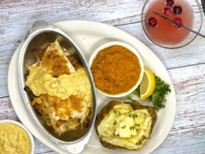 Fresh haddock fillet piled around a flavorful seafood stuffing of fresh clams, crab meat, tiny shrimp and sea scallops; smothered under a creamy saffron sauce with bits of lobster; two sides included